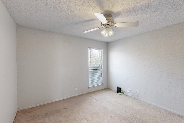 unfurnished room with a textured wall, carpet flooring, ceiling fan, and a textured ceiling