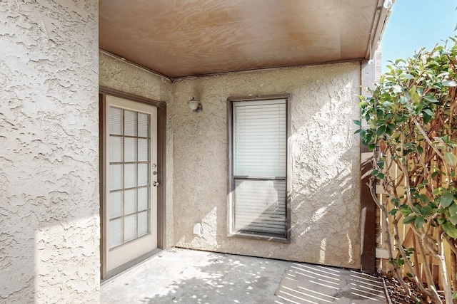 property entrance with stucco siding