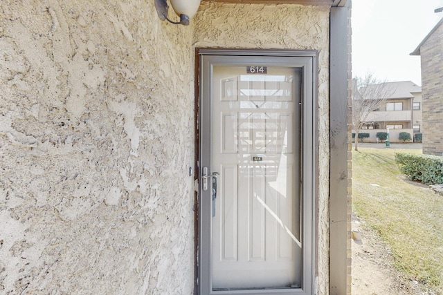 doorway to property with stucco siding