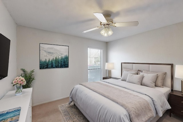 bedroom with light carpet, baseboards, and a ceiling fan