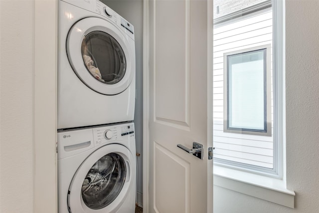 laundry room featuring laundry area and stacked washer / drying machine