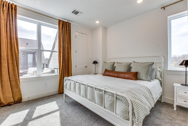 carpeted bedroom featuring recessed lighting, visible vents, and baseboards