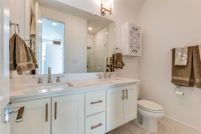 bathroom with double vanity, a stall shower, toilet, and a sink