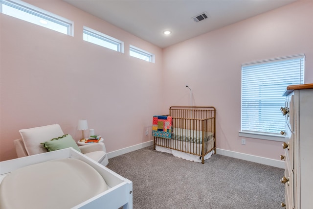 bedroom featuring recessed lighting, visible vents, carpet flooring, a crib, and baseboards