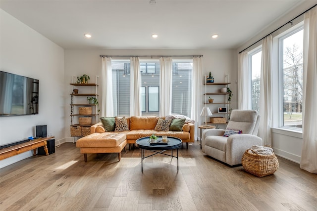 living area with recessed lighting, baseboards, and wood finished floors