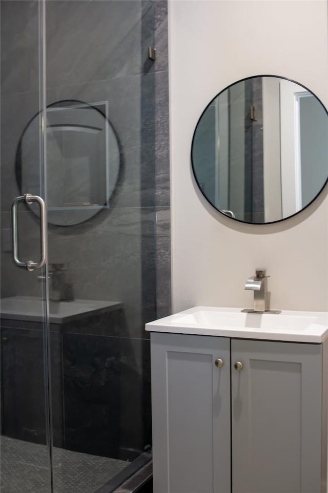 full bath featuring a stall shower and vanity