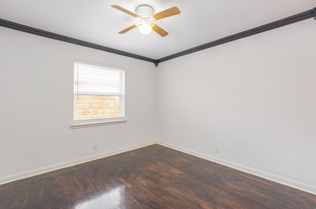 empty room featuring ornamental molding, dark wood-type flooring, a ceiling fan, and baseboards