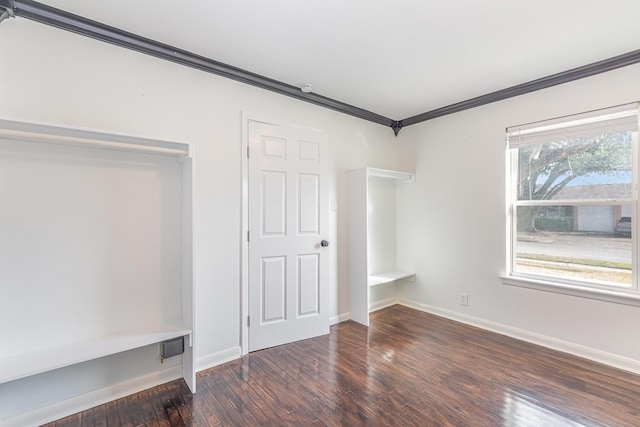 unfurnished bedroom with baseboards, wood-type flooring, and crown molding