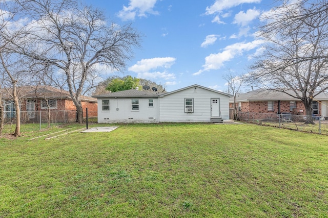 rear view of property featuring crawl space, a fenced backyard, a lawn, and entry steps