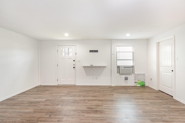 spare room with cooling unit, recessed lighting, baseboards, and wood finished floors