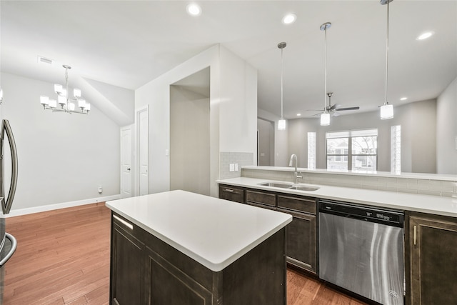 kitchen featuring stainless steel appliances, recessed lighting, light countertops, a sink, and light wood-type flooring