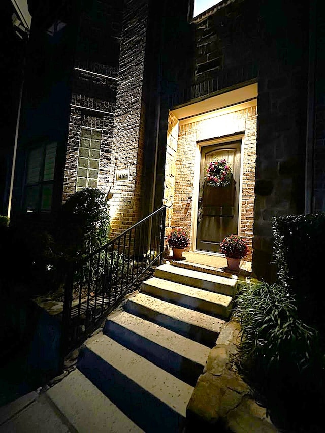 property entrance featuring stone siding