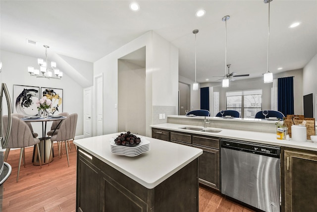 kitchen with tasteful backsplash, dark brown cabinetry, light countertops, dishwasher, and light wood-type flooring