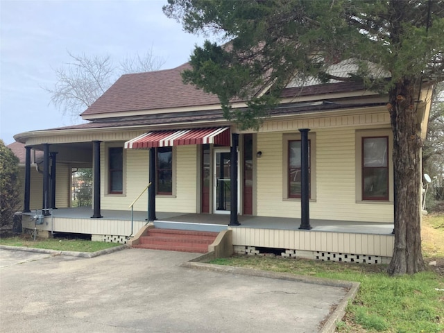 view of front of property featuring a porch and roof with shingles