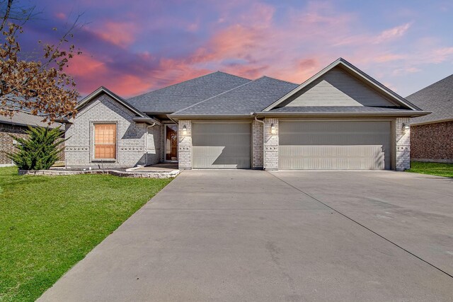 ranch-style house featuring brick siding, concrete driveway, an attached garage, fence, and a front yard