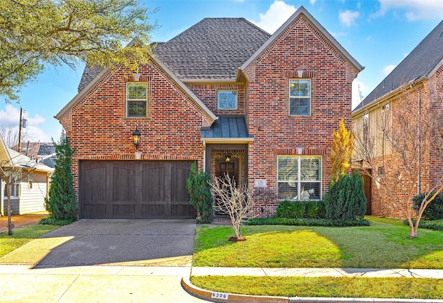 traditional home featuring a garage, brick siding, concrete driveway, roof with shingles, and a front lawn