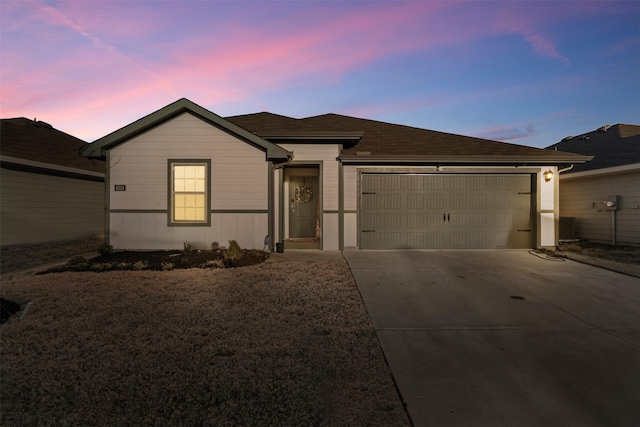 ranch-style home with a garage and concrete driveway