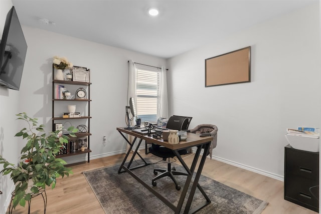 office featuring light wood-style flooring and baseboards