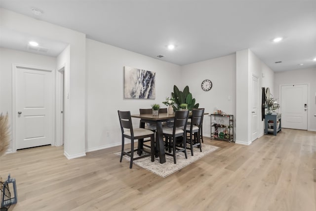 dining area featuring light wood-type flooring and baseboards