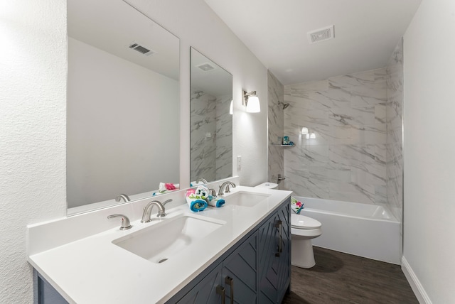 full bathroom featuring visible vents, a sink, toilet, and wood finished floors