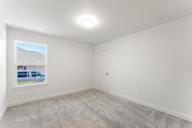 unfurnished room with carpet floors, plenty of natural light, and baseboards