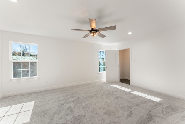 spare room featuring recessed lighting, baseboards, a ceiling fan, and light colored carpet