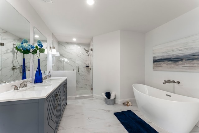 full bath with a marble finish shower, marble finish floor, a freestanding tub, a sink, and recessed lighting