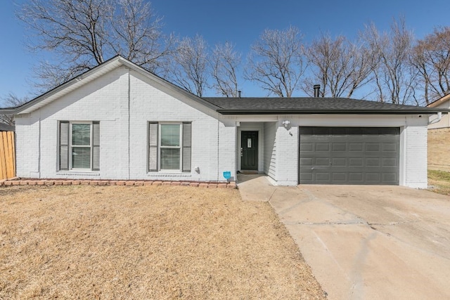 single story home featuring a garage, concrete driveway, and brick siding