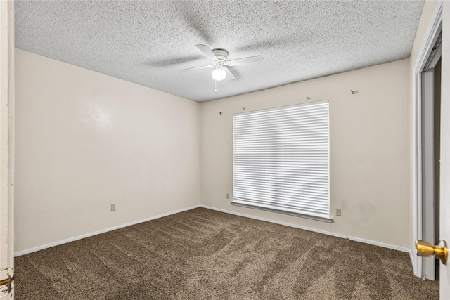 empty room with carpet flooring, ceiling fan, a textured ceiling, and baseboards