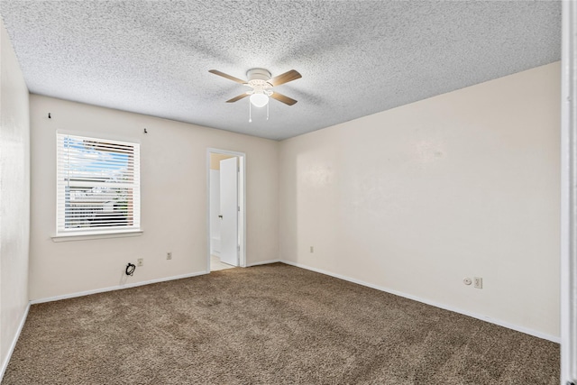 spare room featuring carpet floors, a textured ceiling, baseboards, and a ceiling fan