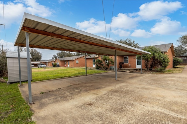 view of vehicle parking with a storage unit, a carport, and concrete driveway