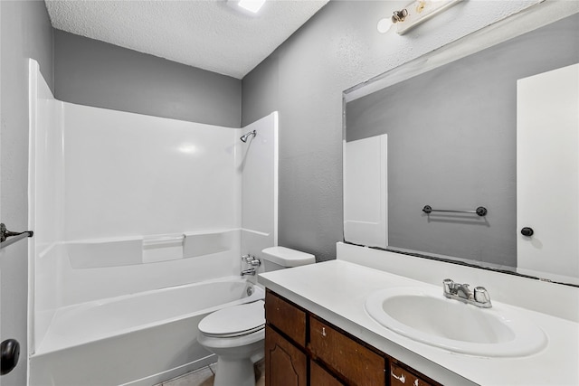 full bath with a textured wall, toilet,  shower combination, a textured ceiling, and vanity