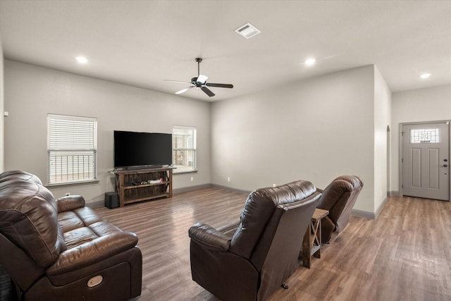 living room featuring visible vents, wood finished floors, and a wealth of natural light