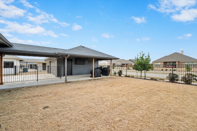 rear view of house featuring a patio area and fence