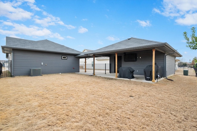 back of house featuring a carport, central AC unit, a patio area, and fence