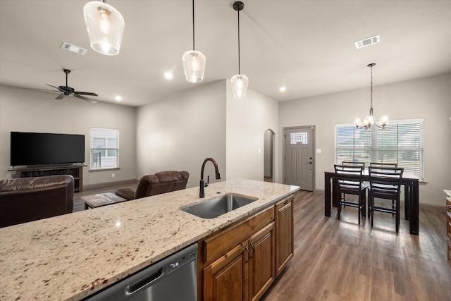 kitchen featuring brown cabinets, visible vents, a sink, and wood finished floors