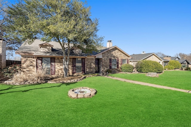 single story home with brick siding, a chimney, fence, a fire pit, and a front lawn