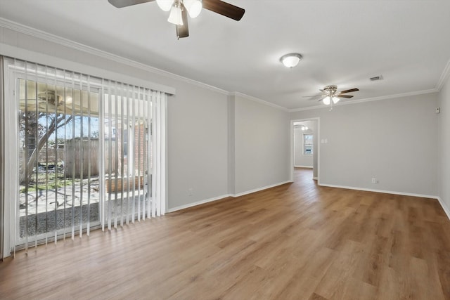 empty room featuring ceiling fan, crown molding, baseboards, and wood finished floors