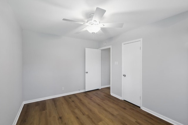 unfurnished room with ceiling fan, baseboards, and wood finished floors