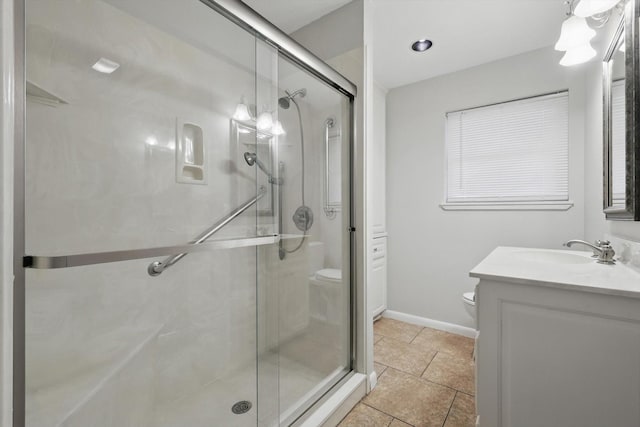 full bathroom with toilet, vanity, baseboards, a shower stall, and tile patterned floors