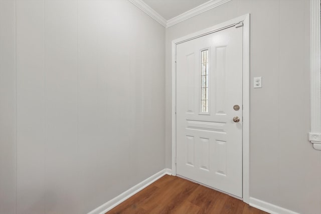 entrance foyer with ornamental molding, baseboards, and dark wood-style floors