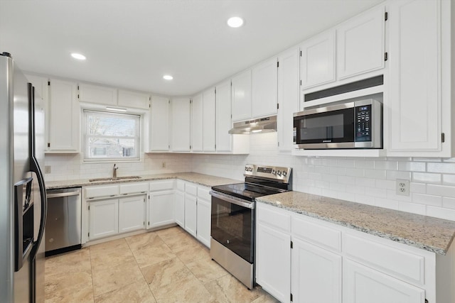 kitchen featuring backsplash, appliances with stainless steel finishes, white cabinets, a sink, and under cabinet range hood