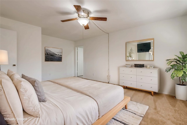 bedroom featuring a ceiling fan and light colored carpet