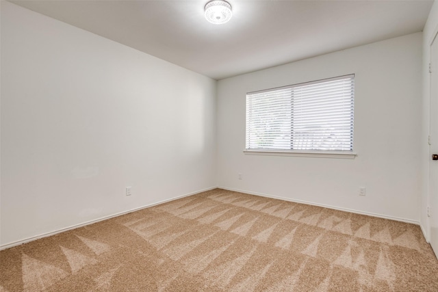 empty room featuring light colored carpet