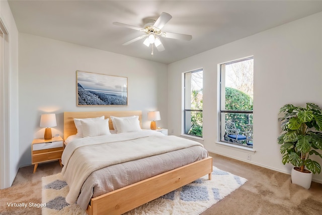 bedroom featuring baseboards, a ceiling fan, and light colored carpet