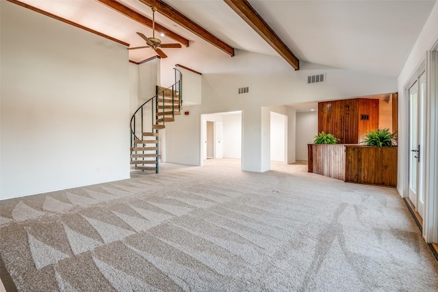 unfurnished living room featuring carpet floors, beam ceiling, stairway, and visible vents