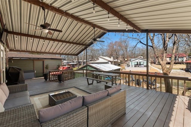 deck featuring outdoor dining space, outdoor lounge area, a grill, and a ceiling fan