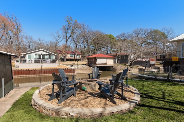 view of yard with a fire pit and fence