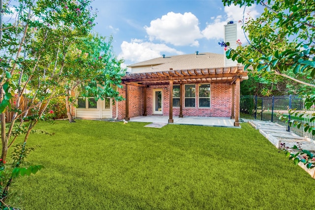 back of property featuring brick siding, a yard, a fenced backyard, and a pergola