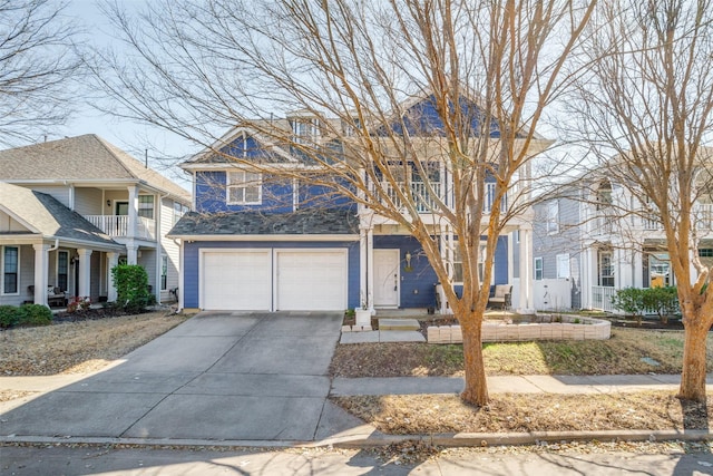 view of front of property featuring concrete driveway, a balcony, and an attached garage